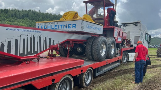 Ein Traktor wird auf einem LKW transportiert 