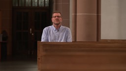 Michael Rind, Anzeigenerstatter gegen Kardinal Woelki, sitzt in einer Kirche