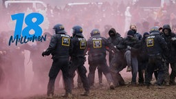 Police in riot gear scuffle with protesters during confrontations near the settlement of Luetzerath on January 14, 2023 near Erkelenz, Germany.