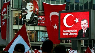 Ein altes Wahlplakat des türkischen Staatspräsidenten Recep Tayyip Erdogan hängt an einer Hausfassade