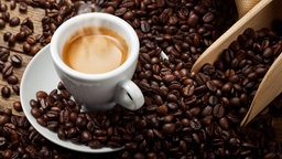 Tasse mit Espresso und Kaffeebohnen