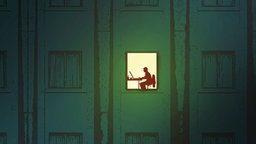 Mann im Home Office nachts im Fenster beleuchtet.