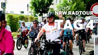 Winkende Radfahrer bei der NRWRadtour 2025