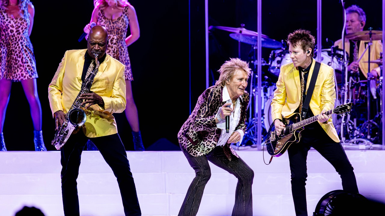 Rod Stewart tanzt auf der Bühne neben seinem Gitarristen