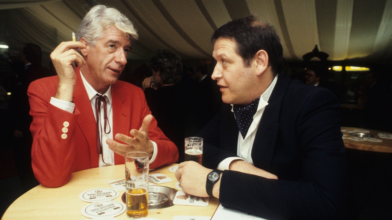 Diether Krebs und Rudi Carrell mit Kölsch am Tisch stehend 