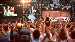 Die Fans jubeln während des Auftritts von "Queen"-Sänger Freddie Mercury beim Live-Aid-Konzert in London 1985