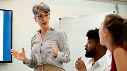 Female business manager doing a presentation during meeting