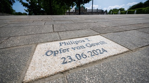 Im Boden vor dem Kaiserpalais im Kurgarten Bad Oeyenhausen ist ein Gedenkstein verlegt. Die Gravur lautet "Philipos T. / Opfer von Gewalt / 23.06.2024"