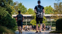Symbolbild: Junge Menschen auf einem Schulhof.