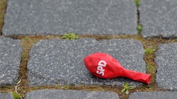 Symbolbild: Ein luftleerer SPD-Ballon liegt auf dem Boden.