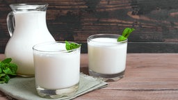 Buttermilch in einer Karaffe und zwei Gläsern