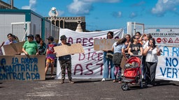 Mehrere Personen während einer Demonstration gegen Aufnahmeeinrichtungen für Migranten im Hafen von La Restinga auf El Hierro.