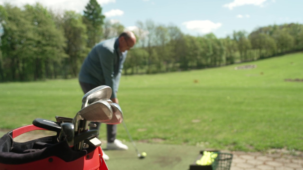 Ein Golfer schlägt den Ball auf einem Golfplatz