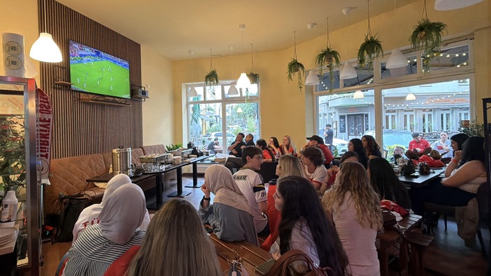 Zuschauer im Cafe verfolgen das Spiel der Türkei