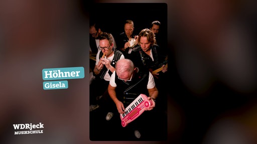 Die Band sitzt in einem engen Studio und spielt auf Kinderinstrumenten