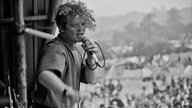 Mick Hucknall auf der Bühne beim Glastonbury Festival 1986
