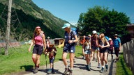 Die Wandergruppe mit Tamina Kallert beim Start auf einem breiten Weg im Tal
