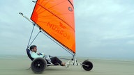 Daniel Aßmann fährt auf einem Strandsegler