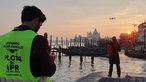 Tamina Kallert steht am Kai und schaut auf Venedig im Sonnenuntergang