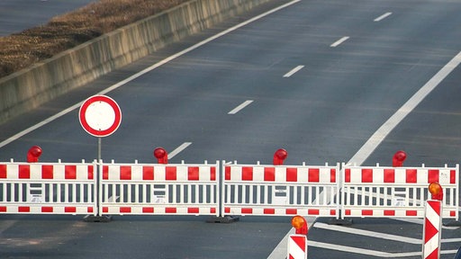 Autobahnsperrung: Rot-weiße Barken versperren die Straße und ein Durchfahrt-verboten-Schild ist aufgestellt