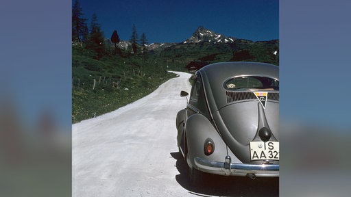 Deutsche Urlauber mit ihrem silbergrauen VW-Käfer in den Alpen auf dem Weg zum Gardasee 1959
